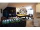 Expansive game room featuring foosball table, pool table, bar, and entertainment area at 447 Shagbark Ct, Mount Gilead, NC 27306