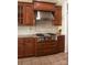 Close-up of the kitchen cooktop area with stainless-steel hood and custom cabinetry at 447 Shagbark Ct, Mount Gilead, NC 27306