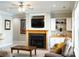 Cozy living room with fireplace, TV, ceiling fan and built-in bar at 447 Shagbark Ct, Mount Gilead, NC 27306