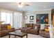 Cozy living room with comfortable sofas, a ceiling fan, neutral color palette, and bright natural light at 447 Shagbark Ct, Mount Gilead, NC 27306