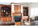 Elegant living room featuring a fireplace with built-in bookshelves and comfortable leather furniture at 447 Shagbark Ct, Mount Gilead, NC 27306