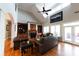 Spacious living room with a soaring ceiling, large windows, and stylish leather seating at 447 Shagbark Ct, Mount Gilead, NC 27306