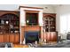 Inviting living room with a fireplace and custom wood built-ins, perfect for cozy evenings at 447 Shagbark Ct, Mount Gilead, NC 27306