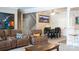Open-concept living room featuring comfortable seating and view into dining area with black table and chairs at 447 Shagbark Ct, Mount Gilead, NC 27306