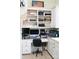 Functional home office space with built-in shelving, a desk, cabinets, and a comfortable rolling chair at 447 Shagbark Ct, Mount Gilead, NC 27306