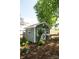 Charming shed with a cottage door nestled in a lush, wooded yard. Ideal for hobbies or storage at 447 Shagbark Ct, Mount Gilead, NC 27306