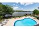 Backyard in-ground swimming pool overlooking a lake at 447 Shagbark Ct, Mount Gilead, NC 27306