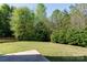 Large backyard with manicured lawn, mature trees, and wooded surroundings for privacy and enjoyment at 4707 Hannah Dr, Rock Hill, SC 29732