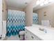 Well-lit bathroom with a white vanity, sink, and shower/tub combo featuring a patterned curtain at 4707 Hannah Dr, Rock Hill, SC 29732