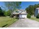 Charming two-story home with a well-manicured lawn, mature trees, and a two-car garage at 4707 Hannah Dr, Rock Hill, SC 29732