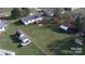 Expansive backyard features a deck, fire pit, various outbuildings, and a swing set at 507 Texas Trl, Dallas, NC 28034