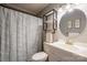 Bathroom featuring a shower, toilet, vanity, and round mirror at 507 Texas Trl, Dallas, NC 28034