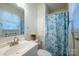 Bright bathroom featuring a floral shower curtain, white vanity and decorated with yellow flowers at 507 Texas Trl, Dallas, NC 28034