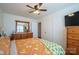 This bedroom features a ceiling fan, neutral walls, and a large window for natural light at 507 Texas Trl, Dallas, NC 28034