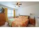 This bedroom features a ceiling fan, neutral walls, and a large window for natural light at 507 Texas Trl, Dallas, NC 28034
