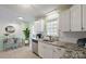 Modern kitchen with white cabinets, granite countertops, stainless steel appliances, and natural light at 507 Texas Trl, Dallas, NC 28034