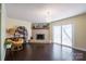 Inviting living room featuring a brick fireplace, wood floors, and sliding glass doors at 507 Texas Trl, Dallas, NC 28034