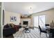 Cozy living room with a brick fireplace, dark wood floors, and a modern light fixture at 507 Texas Trl, Dallas, NC 28034