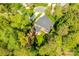 An aerial view highlights the home's backyard and screened porch nestled amongst mature trees, providing privacy at 5103 Trinity Trace Ln, Monroe, NC 28110