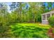 Lush, green backyard offers ample space for recreation and relaxation, complemented by the home's exterior at 5103 Trinity Trace Ln, Monroe, NC 28110