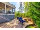 Inviting backyard features a cozy fire pit, grill, and comfortable seating, perfect for outdoor relaxation and entertaining at 5103 Trinity Trace Ln, Monroe, NC 28110