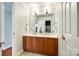 Bright bathroom featuring a double sink vanity, tiled floor, white cabinets, and modern fixtures at 5103 Trinity Trace Ln, Monroe, NC 28110