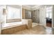Large bathroom with soaking tub, tiled walk-in shower with glass door and tile floors at 5103 Trinity Trace Ln, Monroe, NC 28110