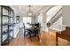 Dining room featuring hardwood floors, a view of foyer, and an elegant chandelier above dining table at 5103 Trinity Trace Ln, Monroe, NC 28110