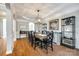 Formal dining room with hardwood floors, a coffered ceiling, and an elegant chandelier above dining table at 5103 Trinity Trace Ln, Monroe, NC 28110
