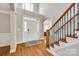 Bright foyer with hardwood floors, elegant staircase, and soaring ceilings showcasing a grand entrance at 5103 Trinity Trace Ln, Monroe, NC 28110