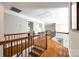 Hallway with hardwood floors, wooden and wrought iron banister, recessed lighting, and access to multiple rooms at 5103 Trinity Trace Ln, Monroe, NC 28110