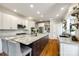 Gourmet kitchen featuring a large island with granite countertops, white cabinets, and stainless steel appliances at 5103 Trinity Trace Ln, Monroe, NC 28110