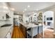Eat-in kitchen with stainless steel appliances, large granite island, and hardwood floors at 5103 Trinity Trace Ln, Monroe, NC 28110