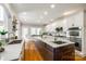 Spacious kitchen with white cabinets, a dark wood island, stainless steel appliances, and hardwood floors at 5103 Trinity Trace Ln, Monroe, NC 28110