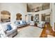 Bright living room with hardwood floors, neutral decor, and a view to the second-story balcony at 5103 Trinity Trace Ln, Monroe, NC 28110