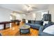 Large living area featuring hardwood floors, a pool table, and a cozy seating area at 5103 Trinity Trace Ln, Monroe, NC 28110