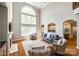 Spacious living room with fireplace, large windows, hardwood floors, and comfortable seating area at 5103 Trinity Trace Ln, Monroe, NC 28110