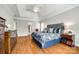 Bright main bedroom featuring a tray ceiling, hardwood floors, and stylish decor at 5103 Trinity Trace Ln, Monroe, NC 28110