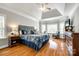 Comfortable bedroom with a tray ceiling, a bay window, a ceiling fan and hardwood floors at 5103 Trinity Trace Ln, Monroe, NC 28110