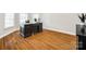 Office space featuring hardwood floors, a desk, and bright natural light from surrounding windows at 5103 Trinity Trace Ln, Monroe, NC 28110