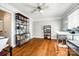 Office with hardwood floors, white ceiling fan, natural light, and shelving units for ample storage at 5103 Trinity Trace Ln, Monroe, NC 28110