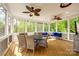 Screened porch with seating area and dining table, perfect for outdoor living and dining at 5103 Trinity Trace Ln, Monroe, NC 28110