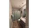 Bathroom with vinyl flooring, a shower/tub combo, and a single sink vanity with drawers at 529 Tribune Dr, Charlotte, NC 28214