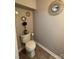 A half bathroom featuring tile flooring, modern toilet, and decorative wall mirrors at 529 Tribune Dr, Charlotte, NC 28214