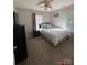 Bedroom featuring a ceiling fan, carpet, large window, and a white bed at 529 Tribune Dr, Charlotte, NC 28214