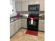 A kitchen with gray cabinets, stainless steel appliances, and tile flooring at 529 Tribune Dr, Charlotte, NC 28214