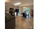 A kitchen with gray cabinets, stainless steel appliances, tile flooring, and dining table at 529 Tribune Dr, Charlotte, NC 28214