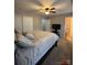 Spacious main bedroom features plush carpet, ceiling fan, and a glimpse into the ensuite bathroom at 529 Tribune Dr, Charlotte, NC 28214