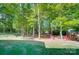 Backyard with mature trees, firepit area, string lights, and lush green grass at 62 Pond View Ln, Fort Mill, SC 29715