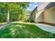 Backyard with lush green grass and mature trees behind the house, leading to the screened in porch at 62 Pond View Ln, Fort Mill, SC 29715